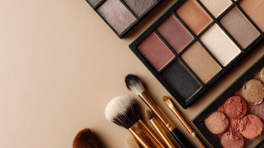 Essory eyeshadow palettes with neutral and warm shades, paired with gold makeup brushes on a beige background, versatile colors for everyday and bold eye looks.
